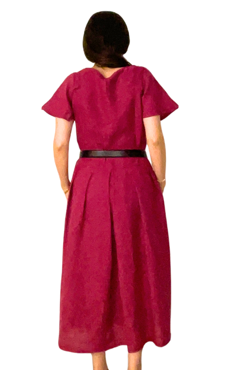Red dress with a belt worn by a person on a white background
