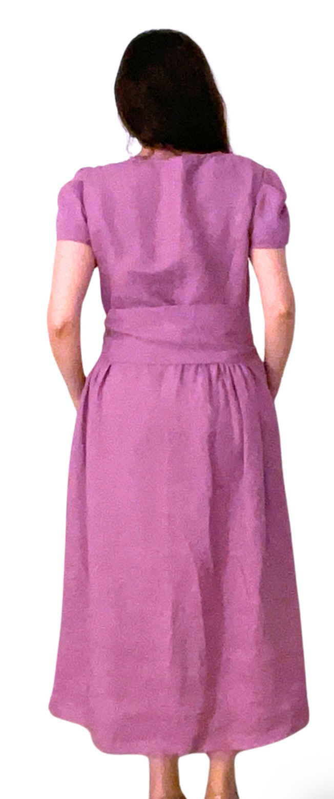 Woman wearing a purple dress with a white background