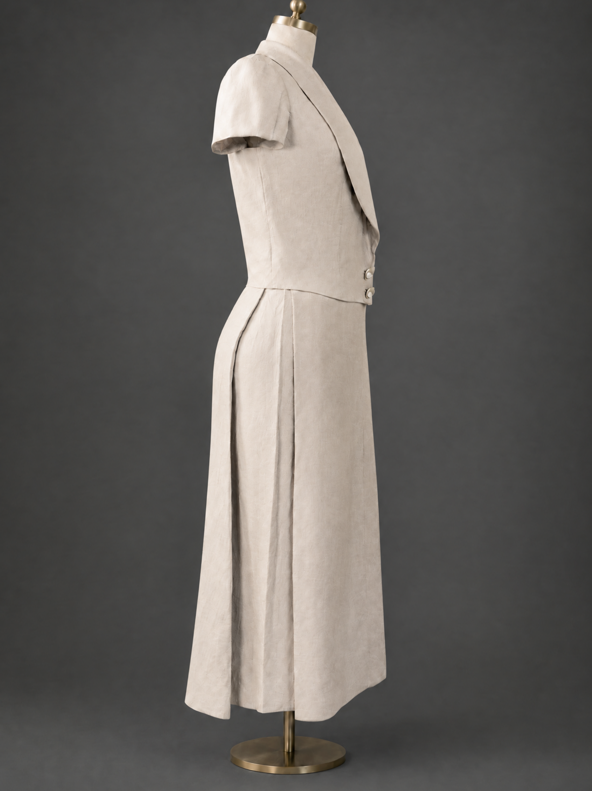 Full right side profile view of The Silent Dove two-piece linen suit on a dress form, emphasizing the clean side lines and premium tailoring.