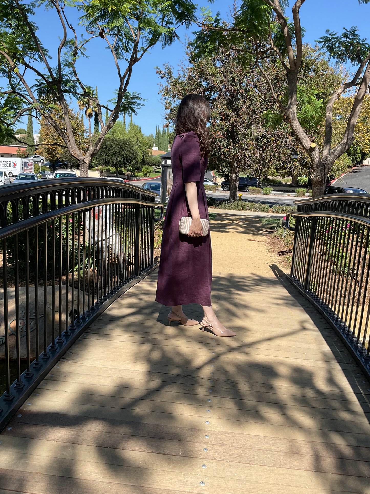 Side profile view of the royal purple linen Amethyst Maxi Dress showing its elegant, tailored silhouette.