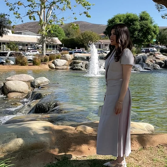 Video showing the movement, fluid flow, and elegant drape of The Silent Dove 2-piece gray linen suit as it spins.